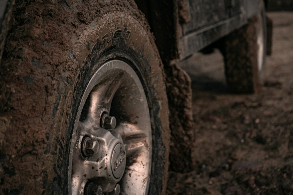 muddy tire tread wheel well close up
