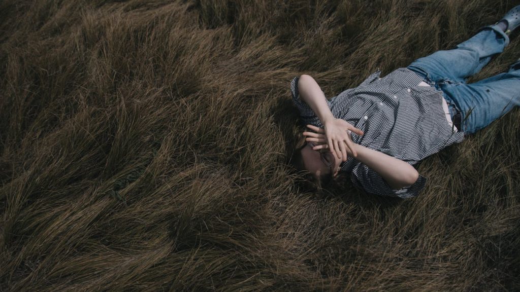 person lying field storm