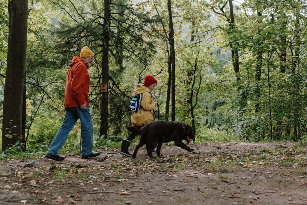 family hiking child close dog leash trail