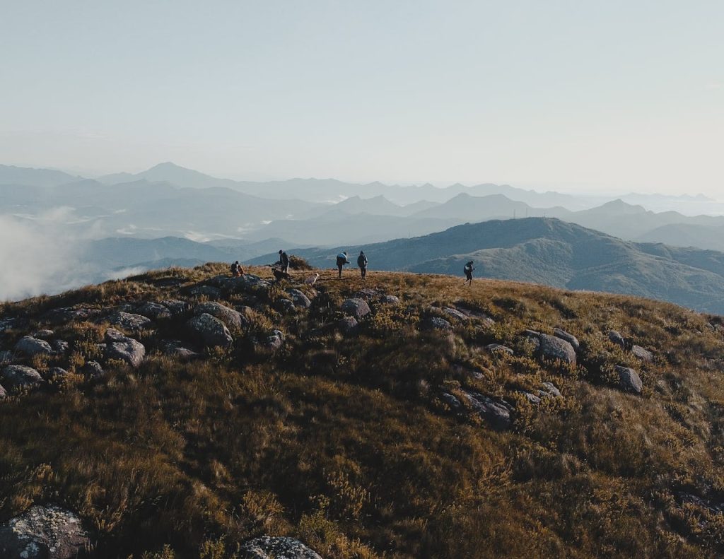 group hikers leaving trail together sunset