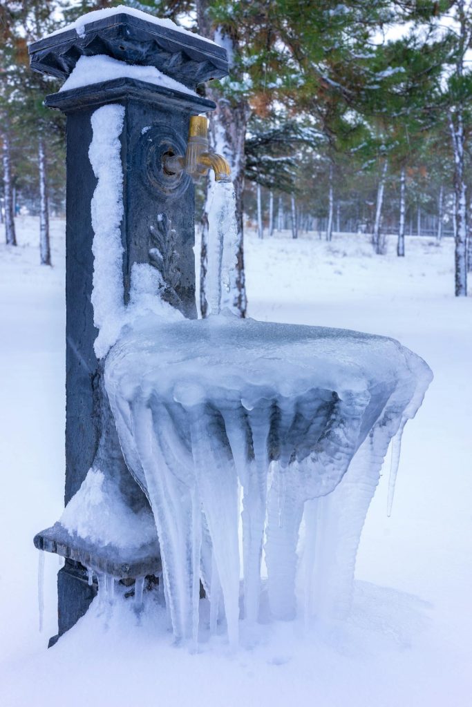 frozen outdoor tap with garden hose