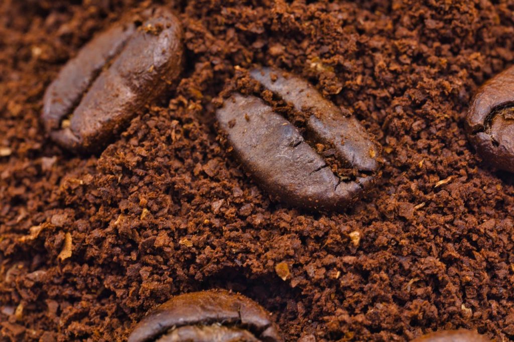 adding coffee grounds to compost
